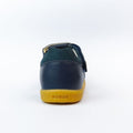 The Bobux iWalk Cross Jump Sandal Navy Closed Toe 636703 is shown from the back, with a navy leather upper, yellow sole featuring BOBUX branding, and set against a white background., 9420062083604, 9420062083611, 9420062083628, 9420062083635, 9420062083642