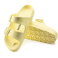 a pair of Birkenstock Arizona EVA Popcorn Yellow Narrow Width with double straps, one over the foot and one over the toes with buckle adjustment. Staps are linked at the sides of the foot. Made of EVA a plastic like material, suitable fot being around water