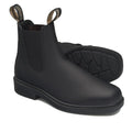 A pair of Blundstone 063 Dress Chelsea Boots in black leather with chisel toes and pull tabs is shown on a white background. One boot stands upright and the other lies on its side, showcasing the textured sole. Suitable for both women and men.