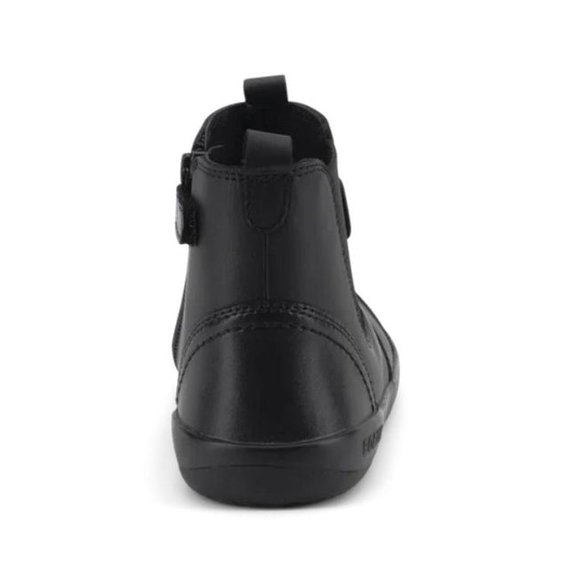 The Bobux Kid+ Black School Leather Boot Jodphur Black Sole Shoes is an ankle-high black leather boot, shown from the back with a top pull tab and visible stitching along the heel and sole, set against a white background., 27690, 9420071306183, 9420071306190, 9420071306206, 9420071306213, 9420071306220, 9420071306237