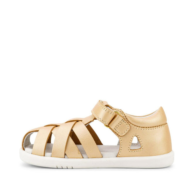 The Bobux Iwalk IW Tropicana II Sandal 638311 in Pale Gold is a closed-back, open-toe sandal with a white sole, multiple Quick Dry Leather straps, and an adjustable hook-and-loop ankle strap for secure fastening., 9420068529946, 9420068529953, 9420068529960, 9420068529977, 9420068529984