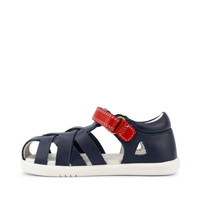 The Bobux Iwalk IW Tropicana II Sandal 638309 in navy features a closed toe, quick dry leather, white sole, ventilating cutouts, red velcro strap across the top, and a small white triangle detail near the heel—perfect for kids., 9420068529779, 9420068529786, 9420068529793, 9420068529809, 9420068529816