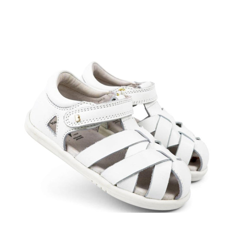 The Bobux Iwalk IW Tropicana II Sandal 638307 White is a children's sandal with closed toes, open sides, Velcro ankle straps, woven quick dry leather, and a flat rubber sole.