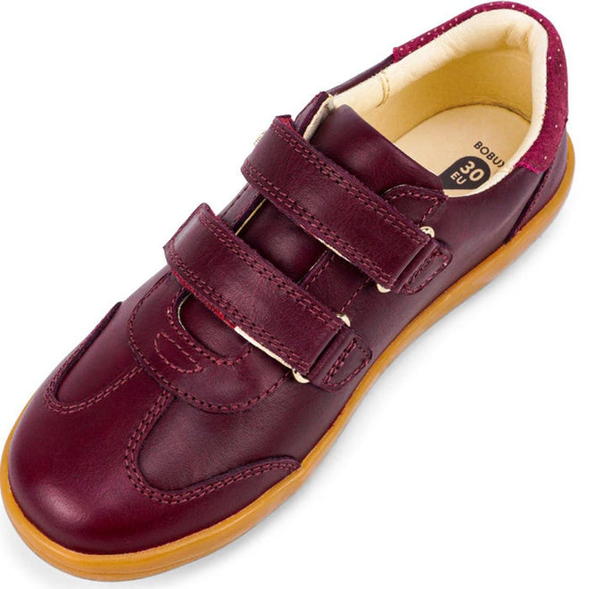 The Bobux Kids Plus KP Sprite Sneaker in Boysenberry is a unisex maroon children’s shoe with two velcro straps, tan rubber sole, and cushioned beige interior, angled to display the top and side., 29968, 9420071316663, 9420071316670, 9420071316687, 9420071316694, 9420071316700, 9420071316717