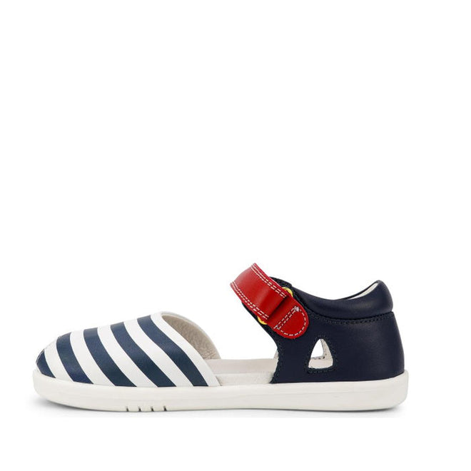 The Bobux Kid + KP Twist Open Toe Sandal Navy features premium leather, navy and white striped front, red Velcro strap, closed back heel support, and a white sole. Displayed in side profile against a white background., 9420068530331, 9420068530348, 9420068530355, 9420068530362, 9420068530379, 24131, 24132