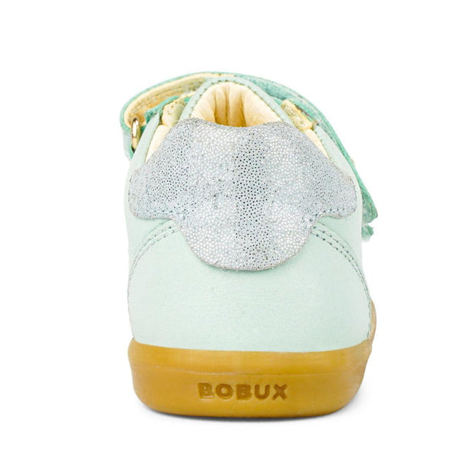 The Bobux Kids IWalk IW Sprite Sneaker in Mist Blue is a unisex children's shoe shown from the back, with a sparkly silver heel accent, tan lining, and a tan rubber sole embossed with the BOBUX brand name., 9420071311095, 9420071311101, 9420071311118, 9420071311125, 9420071311132