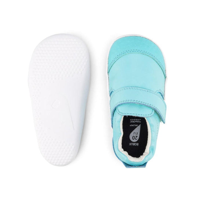 The Bobux Xplorer Go Aqua First Walker Crawler shoes are shown in light blue from top and bottom views, featuring a Velcro strap on top and a flexible, white textured sole for comfort and support., 9420068531673, 9420068531680, 9420068531697, 9420068531703