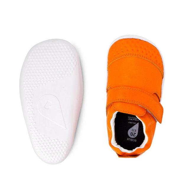 The Bobux Xplorer Go Tangelo First Walker 501035 features small, bright orange baby shoes with white flexible soles and Velcro straps—one shoe shown from the top, the other from the bottom—ideal for little ones' first steps., 9420071309429, 9420071309436, 9420071309443