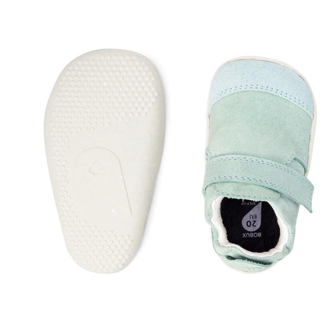 The Bobux XP Xplorer Marvel Mist Blue Dress Shoe First Walker 501227 is shown from above in pale green and light blue sheep leather with a velcro strap, scuff-resistant suede toe cap, and a white flexible non-slip textured sole., 9420071309627, 9420071309634, 9420071309641