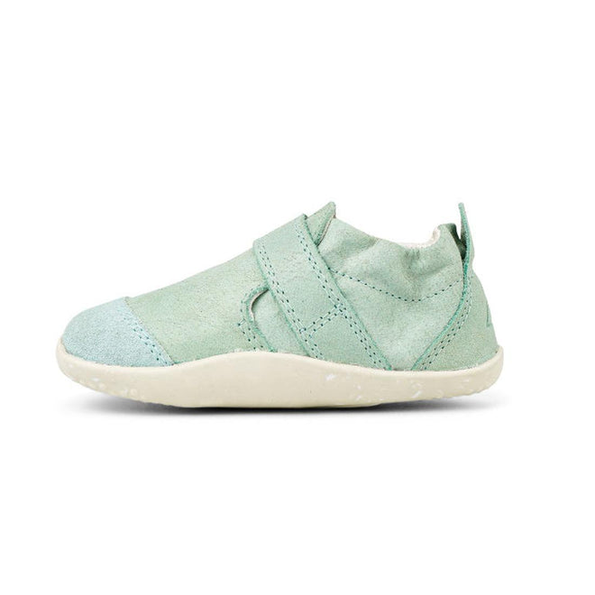 A single Bobux XP Xplorer Marvel Mist Blue Dress Shoe First Walker 501227 with a soft upper, closed toe, and a diagonal strap, shown in profile facing left against a white background., 9420071309627, 9420071309634, 9420071309641