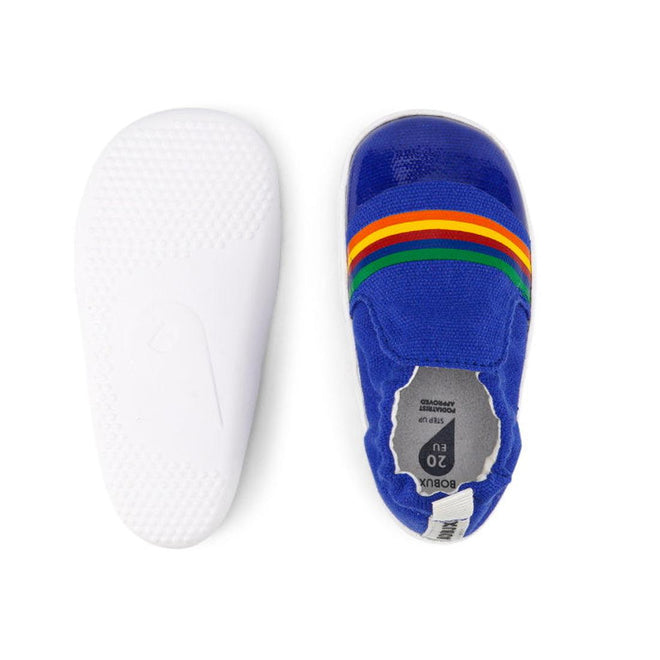 The Bobux Xplorer Scamp Crawler Blueberry Red Rainbow 501711 Canvas baby shoes feature a blue canvas upper with three rainbow stripes and a flexible, white textured rubber sole, shown from both above and below., 9420068534483, 9420068534490, 9420068534506, 9420068534513