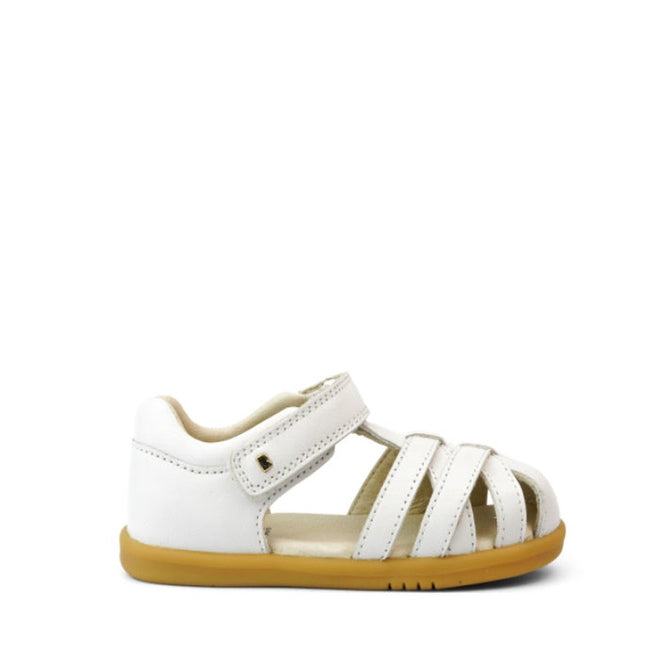 The Bobux iwalk Cross Jump Sandal White Closed Toe 636706 is a white leather toddler sandal with a closed heel, open toe, multiple straps, secure Velcro fastening, and a light brown rubber sole for comfort and support., 9420062083949, 9420062083956, 9420062083963, 9420062083970, 9420062083987