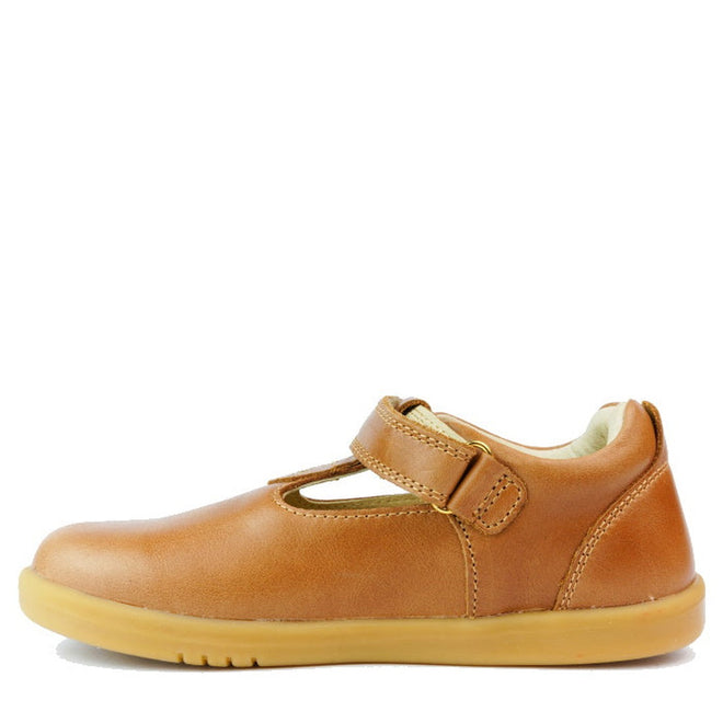 The Bobux Kids Plus KP Louise Caramel Tan T-Bar 833814Z is a brown leather kids’ shoe with a rubber sole, hook-and-loop strap, and classic T-bar cutout design, shown from the side on a white background., 9420068521483, 9420068521490, 9420068521506, 9420068521513, 9420075719293, 9420075719309, 9420075719316