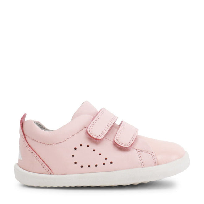 The Bobux Step Up SU Grass Court Trainer 728909J in Seashell Pink features two adjustable Velcro straps, a white sole, and heart-shaped perforations—perfect leather sneakers for toddlers taking their first steps., 9420075792913, 9420075792333, 9420075789821, 9420075791978