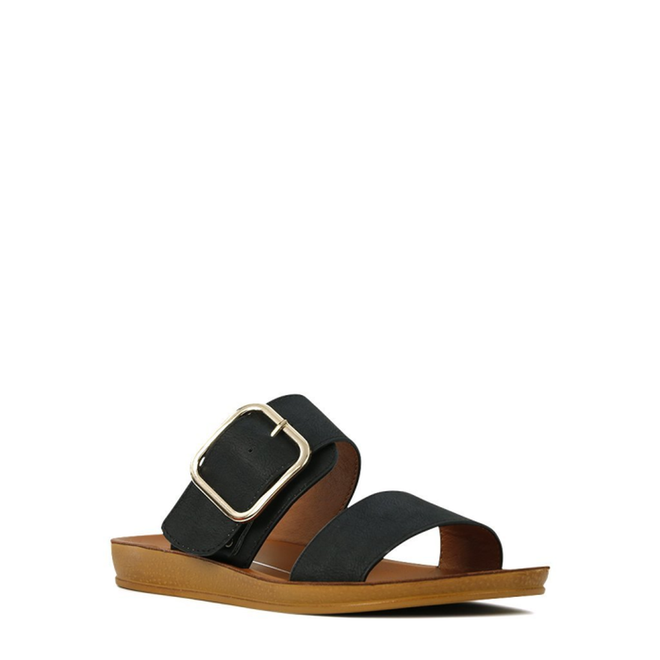 The Los Cabos Doti Black Light Flexible-Sandal features a wide black strap with a gold buckle, a slim toe strap, and a brown flat sole—ideal for travel—shown isolated on a white background., 9321191045450, 9321191045467, 9321191045474, 9321191045481, 9321191045498, 9321191045504, 9321191045511