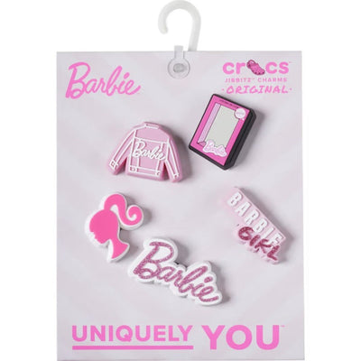 The Crocs Jibbitz 5 Pack - Barbie includes five pink and white charms—a jacket, mirror, ponytail silhouette, “Barbie,” and “Barbie Girl”—to add playful Barbie flair to your Crocs.