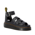 Image of the right foot side on of Dr Martens Clarissa II Quad Platform Sandal Black softer milled nappa leather with a pebbled look. Showing the heel holder and trap around the ankle, 3 straps (not adjustable) over the top of the foot. Yellow stitching around the sole and the quad, double height sole. 