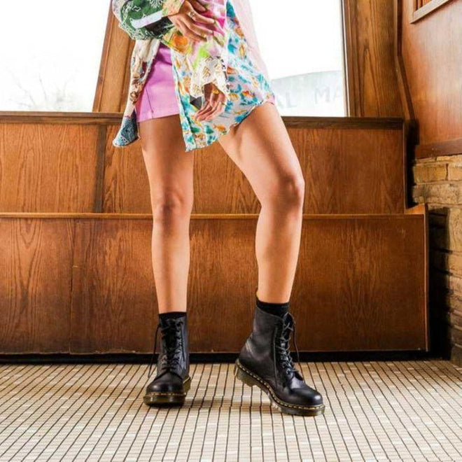 A woman weaing Doc Martens pascal boots in balck showing the finer heel and up the calf. Not as bulkly as the 1460 unisex models.