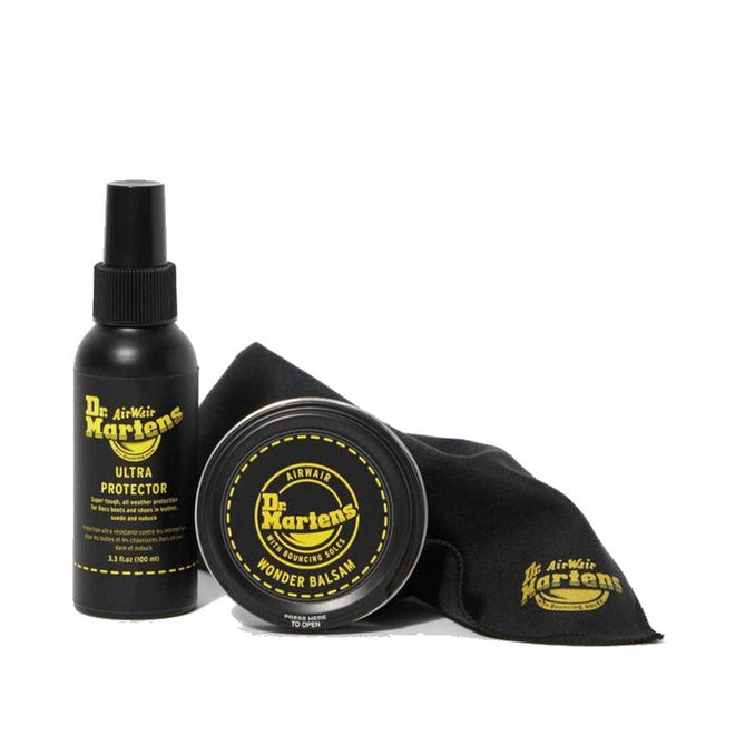 The Dr Martens Shoe Care Kit - Protect includes a black Ultra Protector spray, Wonder Balsam in a round tin, and a black cloth, all with yellow Dr. Martens branding for premium leather care and protection., 190665251302