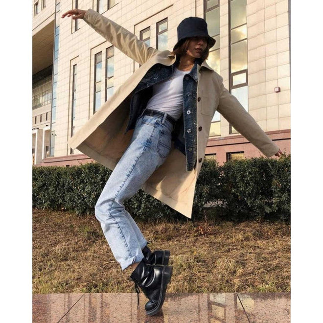 A woman in a coat, t-shirt and jeans on her tippy toes wearing a pair of dr martens 1460 boots.,
800090828511, 800090828535, 800090828542,800090828559.800090828566,800090796377,800090796391, 800090796384