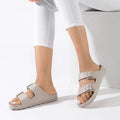A pair of Beige Holster sundreamer sandals on a woman's feet. Shoing the inner side view of the right foot and the outer side view of the left foo. The model is waering whote 3/4 pants and white nail polish.
9337771179989,
9337771179996,
9337771180008,
9337771180015,
9337771180022,
9337771180039,
9337771180046,