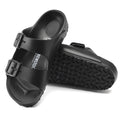 a pair of Birkenstock Kids EVA Black Arizona Sandal Narrow Width Not Suitable for Schoolwear with double straps, one over the foot and one over the toes with buckle adjustment. Staps are linked at the sides of the foot. Made of EVA a plastic like material, suitable fot being around water