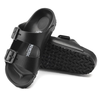 a pair of Birkenstock Kids EVA Black Arizona Sandal Narrow Width Not Suitable for Schoolwear with double straps, one over the foot and one over the toes with buckle adjustment. Staps are linked at the sides of the foot. Made of EVA a plastic like material, suitable fot being around water
