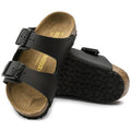 a pair of Birkenstock Kids Black Arizona Sandal Narrow Width Birko Flor with double straps, one over the foot and one over the toes with buckle adjustment. Staps are linked at the sides of the foot. Synthetic straps and a suede leather footbed,
