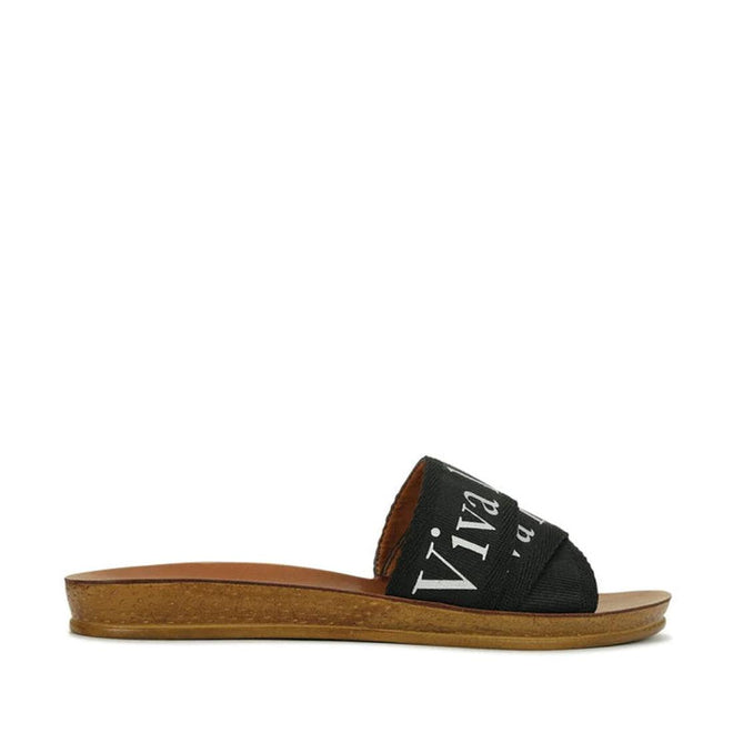 Los Cabos Clar Slip On Slide Black- showing side view of the right foot of the comfy flexible synthetic sandals slides for women
