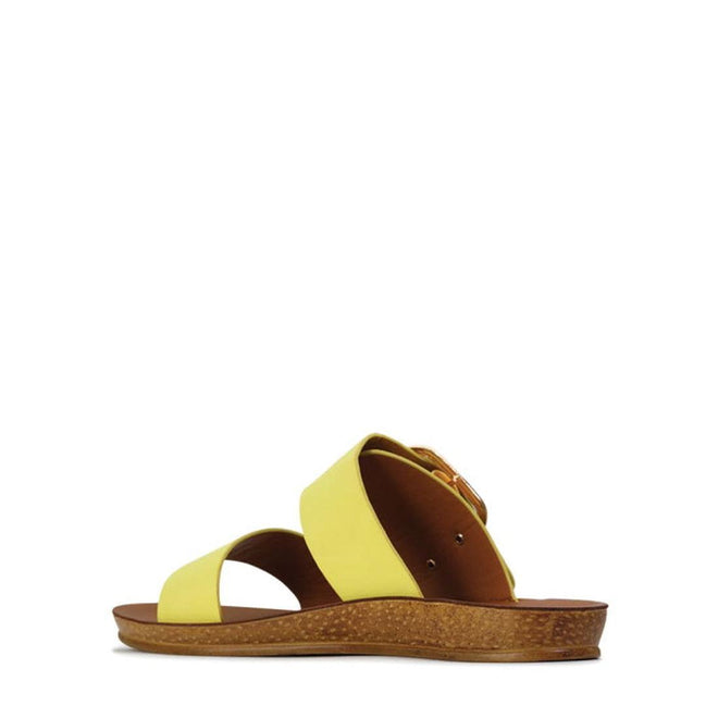 The Los Cabos Doti Citrus Yellow Light Flexible Sandal features two wide straps, an open toe, a cork-textured low wedge sole, and a brown footbed—ideal for travel. CLEARANCE; NOT RETURNABLE. Displayed on a white background., 23673, 23674, 23675, 23676, 23677, 23678, 23679