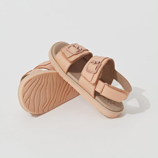 A pair of Pretty Brave Alex Leather Sandals in coral, sizes 29-33, with thick soles, a supportive back strap, two adjustable velcro straps on top, and a comfy leather footbed. One sandal stands while the other leans against it on a white background. CLEARANCE—NOT RETURNABLE., 9421036357554, 9421036357561, 9421036357578, 9421036357585, 9421036357592
