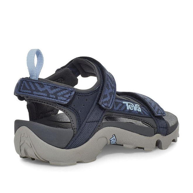 The Teva Boys Active Rugged Sandal K Tanza Blue features thick, textured soles, quick-dry recycled polyester straps in dark blue, a light blue heel pull tab, and adjustable hook-and-loop straps; shown from the back and side on white., 194715413832, 194715413887, 194715413856, 194715413801, 194715413818, 194715413825, 194715413894, 194715413931, 194715413948, 194715413924
