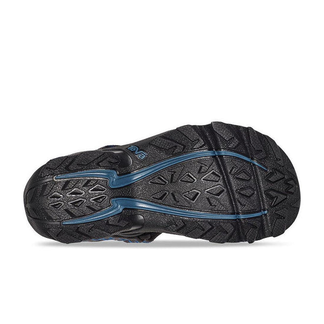 The image shows the black rubber outsole of the Teva Boys Active Rugged Sandal K Tanza Grey, featuring a textured, patterned tread and blue detailing along the center., 24616, 195719344092, 195719344108, 24610, 24611, 24612, 195719344139, 195719344177, 195719344184, 195719344160
